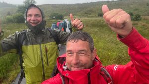two outdoor instructors happy on a rainy DofE expedition